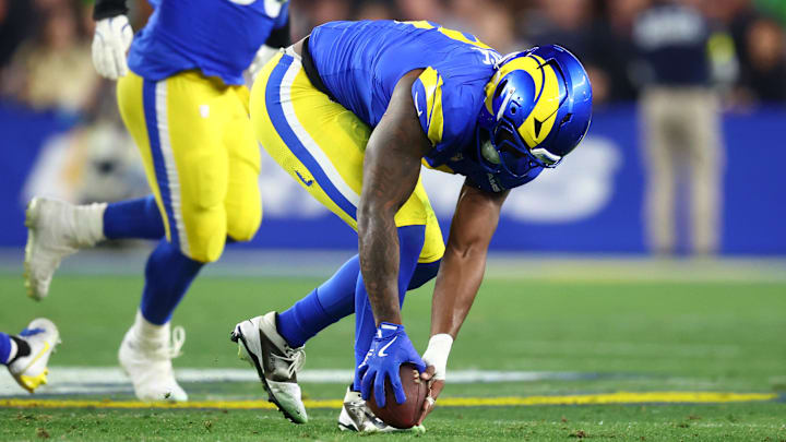 Jan 13, 2025; Glendale, AZ, USA; Los Angeles Rams linebacker Jared Verse (8) recovers a fumble against the Minnesota Vikings during the first half in an NFC wild card game at State Farm Stadium. Mandatory Credit: Mark J. Rebilas-Imagn Images