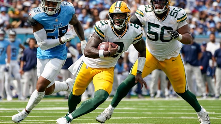 Green Bay Packers quarterback Malik Willis (2) runs the ball past Tennessee Titans linebacker Harold Landry III (58) during the second quarter at Nissan Stadium in Nashville, Tenn., Sunday, Sept. 22, 2024.