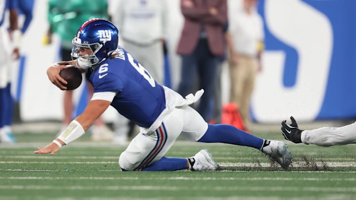 Aug 16, 2025; East Rutherford, New Jersey, USA; New York Giants quarterback Jaxson Dart (6) is tackled during the first half against the New York Jets at MetLife Stadium.  