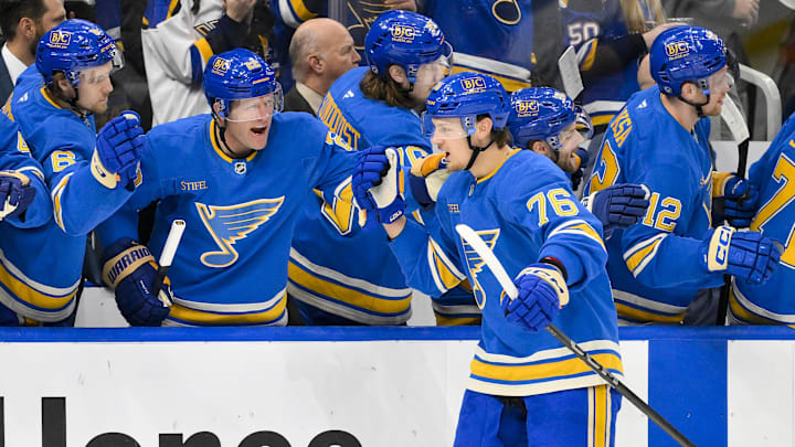 Apr 5, 2025; St. Louis, Missouri, USA;  St. Louis Blues center Zack Bolduc (76) is congratulated by right wing defenseman Ryan Suter (22) and defenseman Philip Broberg (6) after scoring against the Colorado Avalanche during the first period at Enterprise Center. Mandatory Credit: Jeff Curry-Imagn Images