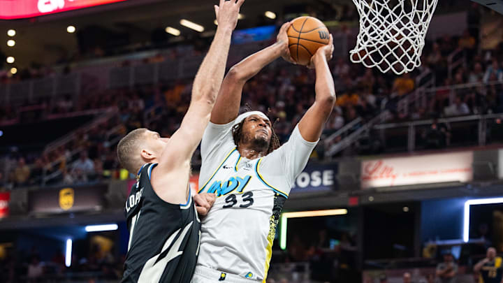 Apr 22, 2025; Indianapolis, Indiana, USA; Indiana Pacers center Myles Turner (33) shoots the ball while Milwaukee Bucks center Brook Lopez (11) defends during game two of first round for the 2024 NBA Playoffs at Gainbridge Fieldhouse. Mandatory Credit: Trevor Ruszkowski-Imagn Images