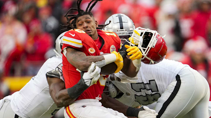 Dec 25, 2023; Kansas City, Missouri, USA; Kansas City Chiefs running back Isiah Pacheco (10) loses his helmet as he is tackled by Las Vegas Raiders defensive end Tyree Wilson (9) and defensive end Malcolm Koonce (51) and cornerback Nate Hobbs (39) during the second half at GEHA Field at Arrowhead Stadium. Mandatory Credit: Jay Biggerstaff-Imagn Images Dec 25, 2023; Kansas City, Missouri, USA; Kansas City Chiefs running back Isiah Pacheco (10) loses his helmet as he is tackled by Las Vegas Raiders defensive end Tyree Wilson (9) and defensive end Malcolm Koonce (51) and cornerback Nate Hobbs (39) during the second half at GEHA Field at Arrowhead Stadium. Mandatory Credit: Jay Biggerstaff-Imagn Images