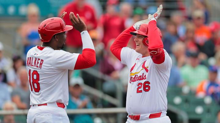 Feb 24, 2025; Jupiter, Florida, USA; St. Louis Cardinals first baseman Luken Baker (26) celebrates with outfielder Jordan Walker (18) after hitting a three-run home run against the New York Mets during the second inning at Roger Dean Chevrolet Stadium. Mandatory Credit: Sam Navarro-Imagn Images