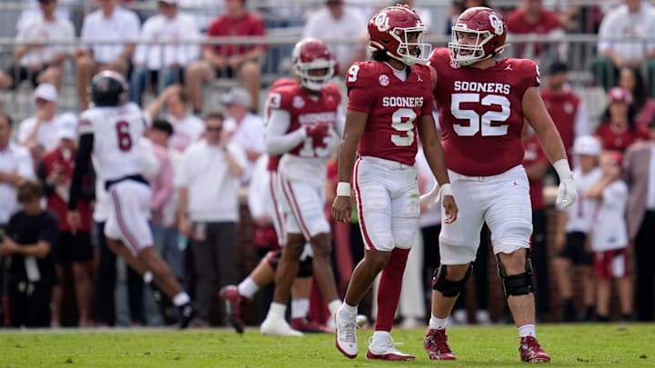 Oklahoma Sooners quarterback Michael Hawkins Jr. walks off the field beside Oklahoma Sooners offensive lineman Troy Everett after a fumble that was returned for a touchdown. Oklahoma Sooners quarterback Michael Hawkins Jr. walks off the field beside Oklahoma Sooners offensive lineman Troy Everett after a fumble that was returned for a touchdown.