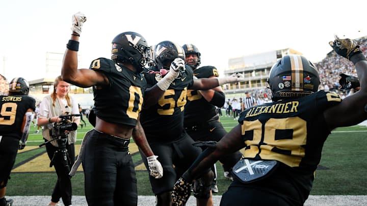 Oct 5, 2024; Nashville, Tennessee, USA;  Vanderbilt Commodores wide receiver Junior Sherrill (0), celebrates his touchdown with his teammates against the Alabama Crimson Tide during the second half at FirstBank Stadium. Mandatory Credit: Steve Roberts-Imagn Images