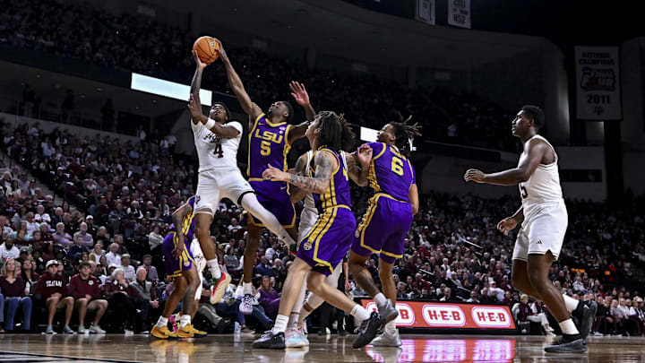Jan 18, 2025; College Station, Texas, USA; Texas A&M Aggies guard Wade Taylor IV (4) shoots the ball as LSU Tigers guard Cam Carter (5) blocks the shot during the first half at Reed Arena. The Aggies defeated the Tigers 68-57. Mandatory Credit: Maria Lysaker-Imagn Images 
