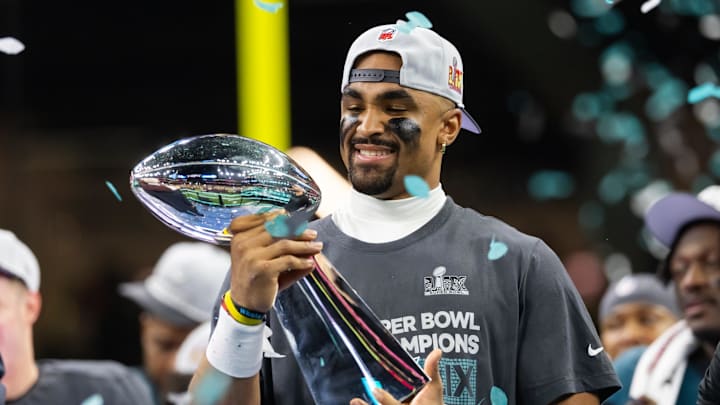 Philadelphia Eagles quarterback Jalen Hurts (1) celebrates with the Vince Lombardi Trophy after defeating the Kansas City Chiefs during Super Bowl LIX at Ceasars Superdome. 
