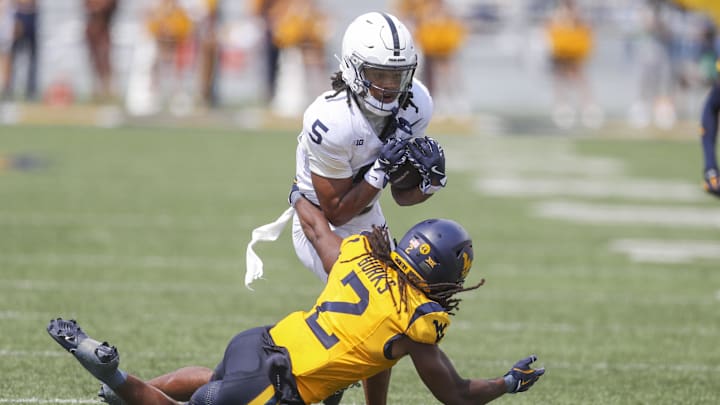 Aug 31, 2024; Morgantown, West Virginia, USA; Penn State Nittany Lions wide receiver Omari Evans (5) make a catch over West Virginia Mountaineers safety Aubrey Burks (2) during the second quarter at Mountaineer Field at Milan Puskar Stadium. 