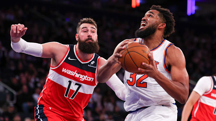 Oct 9, 2024; New York, New York, USA; New York Knicks center Karl-Anthony Towns (32) drives to the basket against Washington Wizards center Jonas Valanciunas (17) during the second half at Madison Square Garden. Mandatory Credit: Vincent Carchietta-Imagn Images