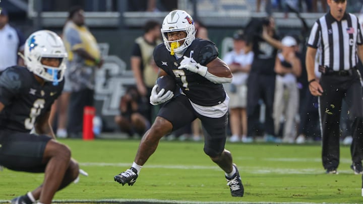 Sep 7, 2024; Orlando, Florida, USA; UCF Knights running back RJ Harvey (7) carries the ball during the first quarter against the Sam Houston State Bearkats at FBC Mortgage Stadium. Mandatory Credit: Mike Watters-Imagn Images