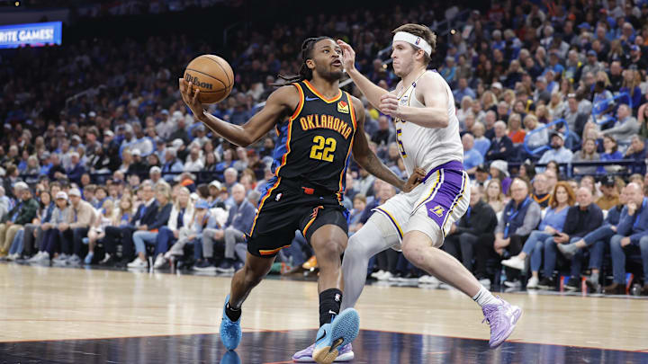Apr 6, 2025; Oklahoma City, Oklahoma, USA; Oklahoma City Thunder guard Cason Wallace (22) drives to the basket against Los Angeles Lakers guard Austin Reaves (15) during the second half at Paycom Center. Mandatory Credit: Alonzo Adams-Imagn Images