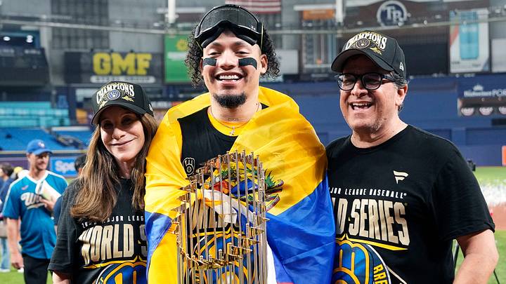 Milwaukee Brewers catcher William Contreras (24) takes a photo with Brewers owner Mark Attanasio, right, and his wife Debbie Attanasio, left, after winning the World Series against the Tampa Bay Rays at Tropicana Field on in St.Petersburg, Florida on Oct. 28, 2026.