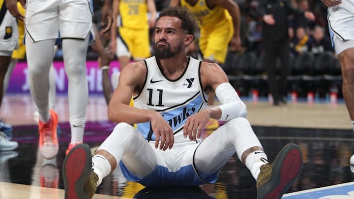 Mar 8, 2025; Atlanta, Georgia, USA; Atlanta Hawks guard Trae Young (11) sits on the court after being fouled by Indiana Pacers forward Pascal Siakam (43) during the first quarter at State Farm Arena. Mandatory Credit: Mady Mertens-Imagn Images
