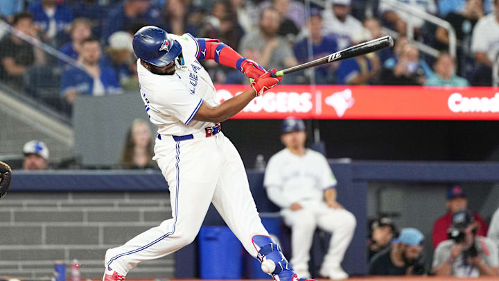 Sep 27, 2024; Toronto, Ontario, CAN; Toronto Blue Jays first base Vladimir Guerrero Jr. (27) takes a ball off the ankle against the Miami Marlins during the fifth inning at Rogers Centre. Mandatory Credit: Nick Turchiaro-Imagn Images