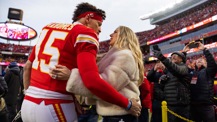 Kansas City Chiefs quarterback Patrick Mahomes (15) and wife Brittany Mahomes kiss before the AFC Championship game against the Buffalo Bills at GEHA Field at Arrowhead Stadium.