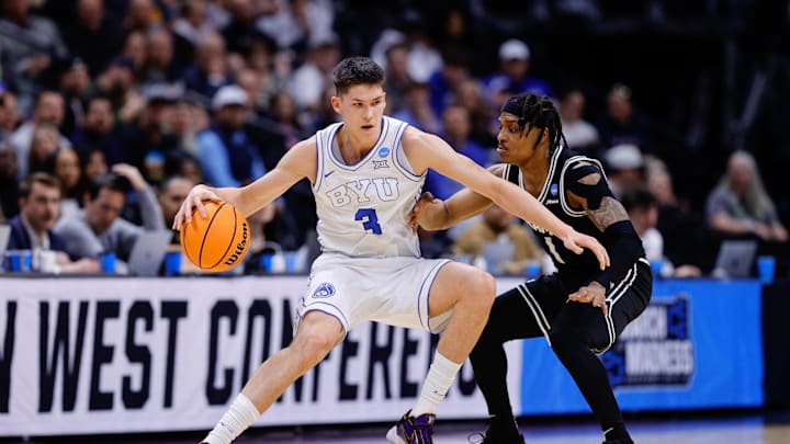 Mar 20, 2025; Denver, CO, USA; Brigham Young Cougars guard Egor Demin (3) dribbles the ball against VCU Rams guard Phillip Russell (1) during the first half in the first round of the NCAA Tournament at Ball Arena. Mandatory Credit: Isaiah J. Downing-Imagn Images