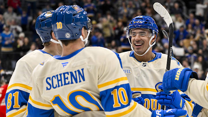 Feb 8, 2025; St. Louis, Missouri, USA;  St. Louis Blues right wing Mathieu Joseph (71) celebrates with center Dylan Holloway (81) and center Brayden Schenn (10) after scoring against the Chicago Blackhawks during the second period at Enterprise Center. Mandatory Credit: Jeff Curry-Imagn Images