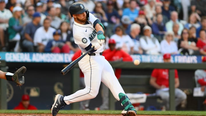 Jul 23, 2024; Seattle, Washington, USA; Seattle Mariners first baseman Tyler Locklear (27) hits a single against the Los Angeles Angels during the second inning at T-Mobile Park. Mandatory Credit: Steven Bisig-Imagn Images