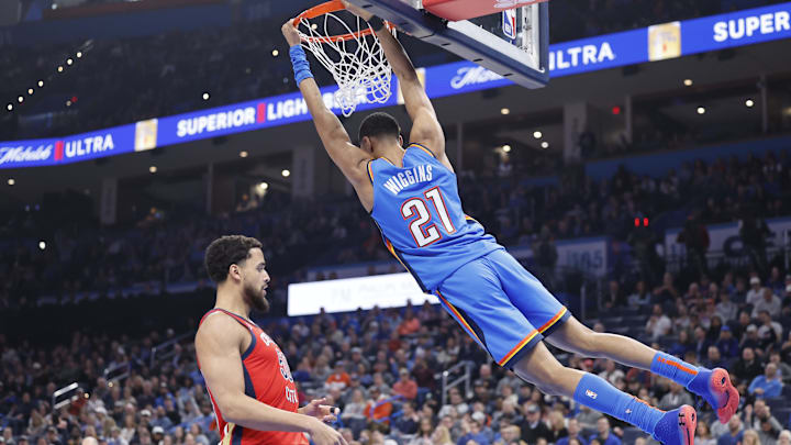 Feb 10, 2025; Oklahoma City, Oklahoma, USA; Oklahoma City Thunder guard Aaron Wiggins (21) dunks in front of New Orleans Pelicans forward Jeremiah Robinson-Earl (50) during the second quarter at Paycom Center. Mandatory Credit: Alonzo Adams-Imagn Images Feb 10, 2025; Oklahoma City, Oklahoma, USA; Oklahoma City Thunder guard Aaron Wiggins (21) dunks in front of New Orleans Pelicans forward Jeremiah Robinson-Earl (50) during the second quarter at Paycom Center. Mandatory Credit: Alonzo Adams-Imagn Images