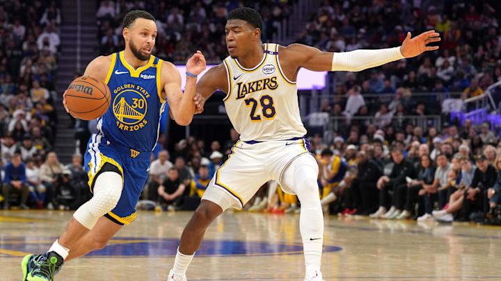 Dec 25, 2024; San Francisco, California, USA; Golden State Warriors guard Stephen Curry (30) dribbles against Los Angeles Lakers forward Rui Hachimura (28) during the fourth quarter at Chase Center. Mandatory Credit: Darren Yamashita-Imagn Images