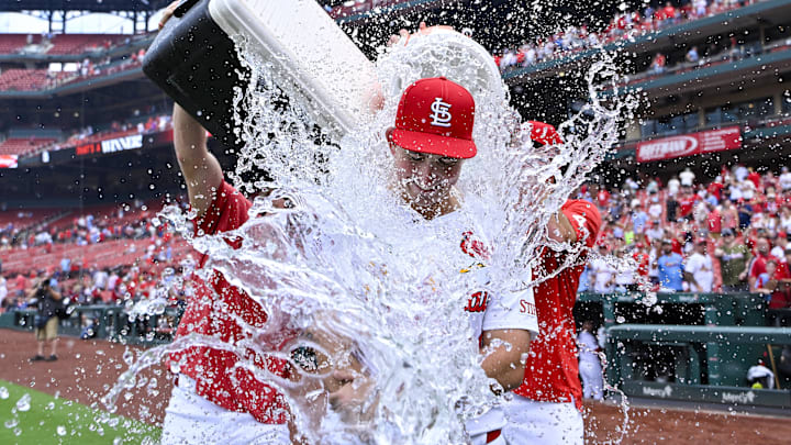 Jul 31, 2024; St. Louis, Missouri, USA;  St. Louis Cardinals starting pitcher Michael McGreevy (36) is doused with water by pitcher Miles Mikolas (left) and pitcher Kyle Gibson (right) after winning his first MLB game in his Major League Debut against the Texas Rangers at Busch Stadium. Mandatory Credit: Jeff Curry-Imagn Images