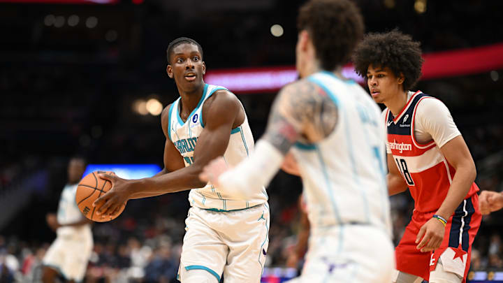 Oct 26, 2025; Washington, District of Columbia, USA; Charlotte Hornets forward Moussa Diabate (14) looks to pass the ball to guard LaMelo Ball (1) in front of Washington Wizards forward Kyshawn George (18) during the third quarter at Capital One Arena. Mandatory Credit: Rafael Suanes-Imagn Images Oct 26, 2025; Washington, District of Columbia, USA; Charlotte Hornets forward Moussa Diabate (14) looks to pass the ball to guard LaMelo Ball (1) in front of Washington Wizards forward Kyshawn George (18) during the third quarter at Capital One Arena. Mandatory Credit: Rafael Suanes-Imagn Images