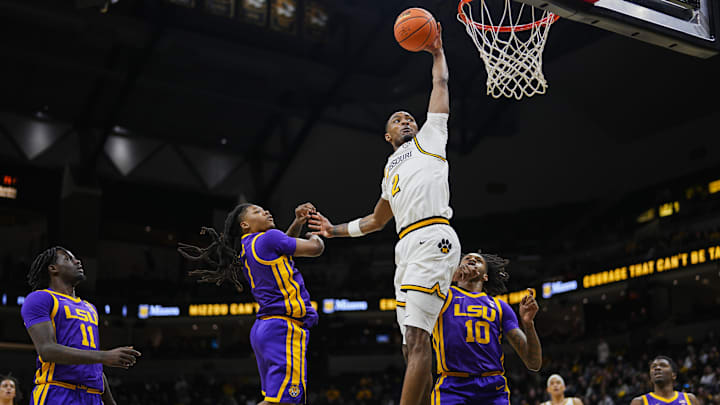 Jan 7, 2025; Columbia, Missouri, USA; Missouri Tigers guard Tamar Bates (2) goes up for a dunk against the LSU Tigers during the first half at Mizzou Arena. Mandatory Credit: Jay Biggerstaff-Imagn Images