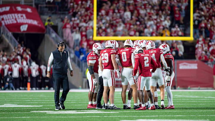 Oct 11, 2025; Madison, Wisconsin, USA; Wisconsin Badgers head coach Luke Fickell and the Wisconsin defensive huddle up in the second half against the Iowa Hawkeyes at Camp Randall Stadium. Mandatory Credit: Ross Harried-Imagn Images Oct 11, 2025; Madison, Wisconsin, USA; Wisconsin Badgers head coach Luke Fickell and the Wisconsin defensive huddle up in the second half against the Iowa Hawkeyes at Camp Randall Stadium. Mandatory Credit: Ross Harried-Imagn Images