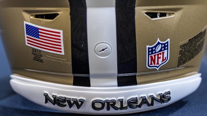 Mar 11, 2023; Metairie, LA, USA; Detailed view of New Orleans Saints helmet at Ochsner Sports Performance Center. Mandatory Credit: Stephen Lew-Imagn Images Mar 11, 2023; Metairie, LA, USA; Detailed view of New Orleans Saints helmet at Ochsner Sports Performance Center. Mandatory Credit: Stephen Lew-Imagn Images