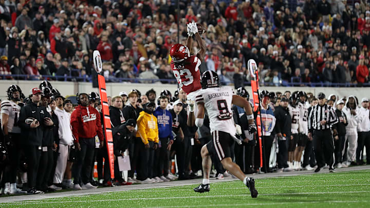 Razorback freshman Dazmin James goes up for a catch over Texas Tech senior defensive back C.J. Baskerville during Friday's 39-26 Arkansas victory in the 2024 Liberty Bowl in Memphis.