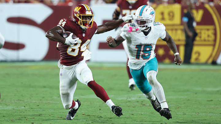 Washington Commanders wide receiver Jacoby Jones (84) runs with the ball as Miami Dolphins linebacker Kyle Louis (19) defends during the second half at Northwest Stadium. Washington Commanders wide receiver Jacoby Jones (84) runs with the ball as Miami Dolphins linebacker Kyle Louis (19) defends during the second half at Northwest Stadium.
