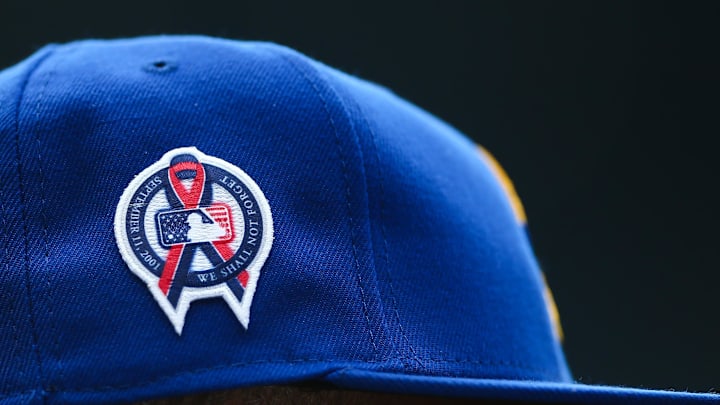 A patch remembering the September 11th terrorist attacks is seen on a Seattle Mariners hat during the game against the Atlanta Braves at T-Mobile Park in 2022.