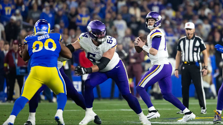Jan 13, 2025; Glendale, AZ, USA; Minnesota Vikings quarterback Sam Darnold (14) against the Los Angeles Rams during an NFC wild card game at State Farm Stadium. Mandatory Credit: Mark J. Rebilas-Imagn Images