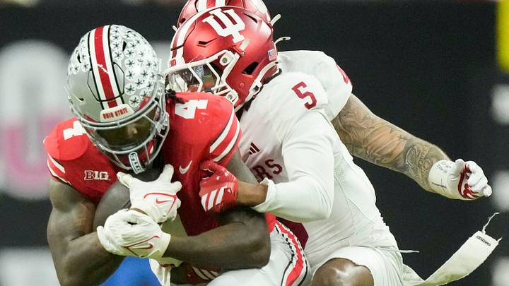Indiana Hoosiers defensive back D'Angelo Ponds (5) works to bring down Ohio State Buckeyes wide receiver Jeremiah Smith (4) on Saturday, Dec. 6, 2025, during the Big Ten football championship at Lucas Oil Stadium in Indianapolis.