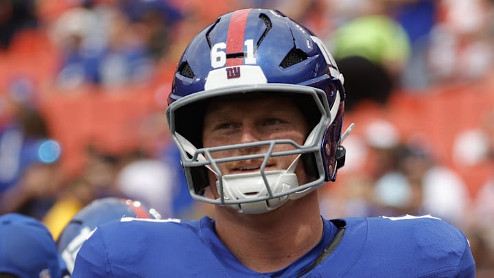 Sep 7, 2025; Landover, Maryland, USA; New York Giants center John Michael Schmitz Jr. (61) runs onto the field prior to the game against the Washington Commanders at Northwest Stadium.  
