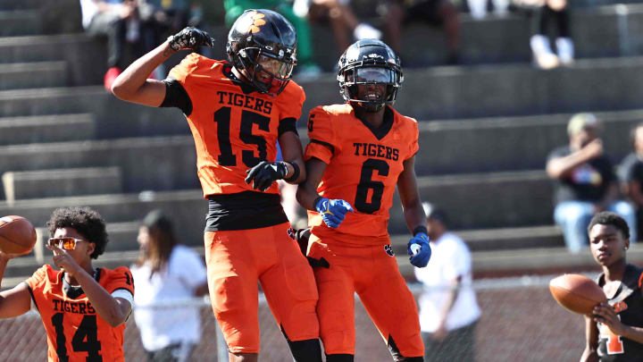 Withrow's Chris Henry Jr (15) and Kristian Bonner (6) celebrate during the Tigers' 31-0 win over Taft Saturday, Sept. 23. 2023.