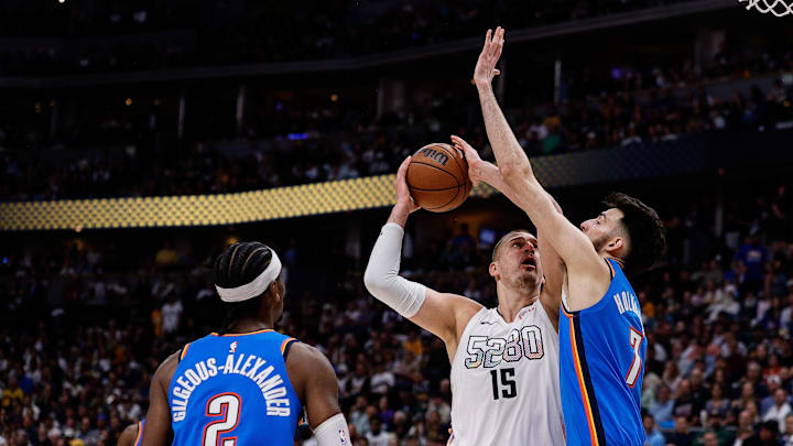 May 15, 2025; Denver, Colorado, USA; Denver Nuggets center Nikola Jokic (15) drives to the net against Oklahoma City Thunder forward Chet Holmgren (7) as guard Shai Gilgeous-Alexander (2) defends in the third quarter during game six of the second round for the 2025 NBA Playoffs at Ball Arena. Mandatory Credit: Isaiah J. Downing-Imagn Images May 15, 2025; Denver, Colorado, USA; Denver Nuggets center Nikola Jokic (15) drives to the net against Oklahoma City Thunder forward Chet Holmgren (7) as guard Shai Gilgeous-Alexander (2) defends in the third quarter during game six of the second round for the 2025 NBA Playoffs at Ball Arena. Mandatory Credit: Isaiah J. Downing-Imagn Images