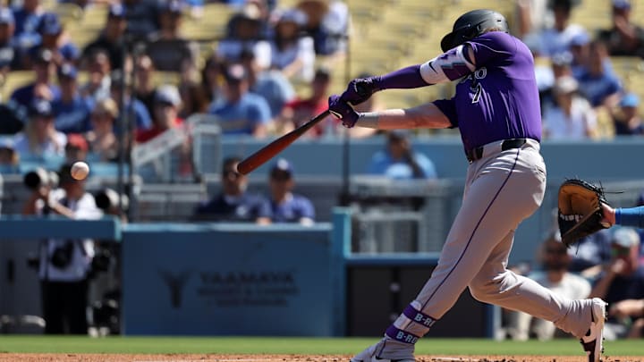 Sep 22, 2024; Los Angeles, California, USA; Colorado Rockies second baseman Brendan Rodgers (7) hits an RBI single during the first inning against the Los Angeles Dodgers at Dodger Stadium. 