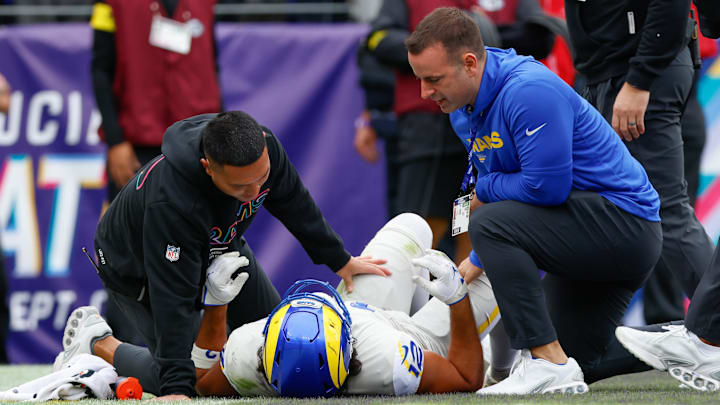 Oct 12, 2025; Baltimore, Maryland, USA; Los Angeles Rams wide receiver Puka Nacua (12) is checked on by trainers during the second quarter of the game against the Baltimore Ravens at M&T Bank Stadium. Mandatory Credit: Peter Casey-Imagn Images Oct 12, 2025; Baltimore, Maryland, USA; Los Angeles Rams wide receiver Puka Nacua (12) is checked on by trainers during the second quarter of the game against the Baltimore Ravens at M&T Bank Stadium. Mandatory Credit: Peter Casey-Imagn Images
