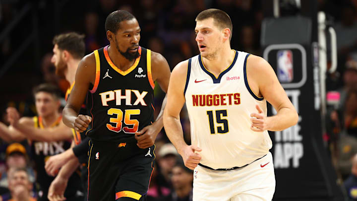 Dec 1, 2023; Phoenix, Arizona, USA; Phoenix Suns forward Kevin Durant (35) against Denver Nuggets center Nikola Jokic (15) in the first half at Footprint Center. Mandatory Credit: Mark J. Rebilas-Imagn Images