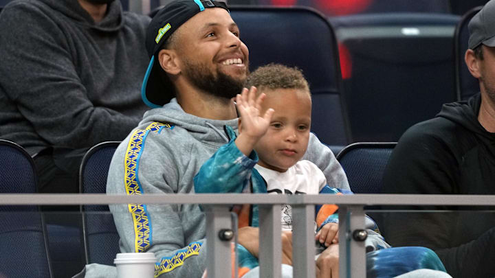 Golden State Warriors guard Stephen Curry (30) sits in the stands with son Canon during the second quarter against the Sacramento Kings at the California Summer League back in 2022.