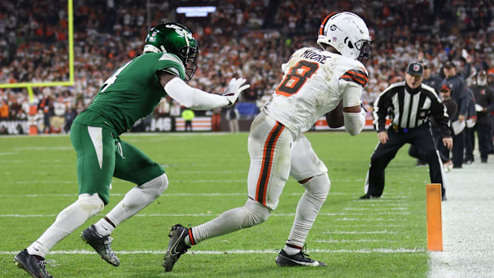 Dec 28, 2023; Cleveland, Ohio, USA; Cleveland Browns wide receiver Elijah Moore (8) catches a touchdown pass ahead of New York Jets cornerback D.J. Reed (4) during the first half at Cleveland Browns Stadiums
