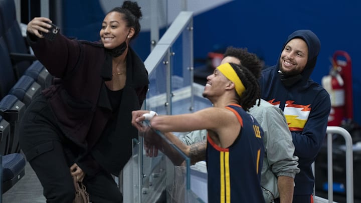 Sydel Curry (far left) takes a selfie with Golden State Warriors guard Damion Lee (second from left), Philadelphia 76ers guard Seth Curry (second from right), and Warriors guard Stephen Curry (far right) after the game at Chase Center.