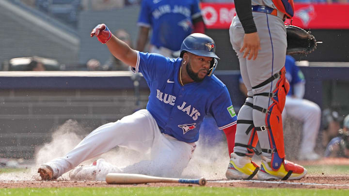 Toronto, Ontario, CAN; Toronto Blue Jays first baseman Vladimir Guerrero Jr. (27) slides into home plate scoring a run against the New York Mets during the fourth inning at Rogers Centre.