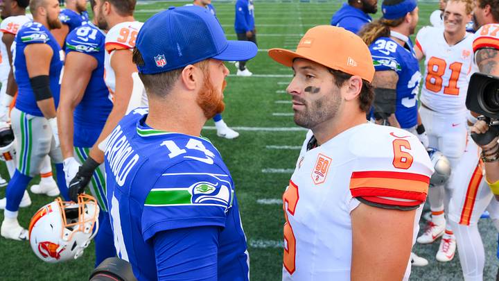 Seattle Seahawks quarterback Sam Darnold (14) and Tampa Bay Buccaneers quarterback Baker Mayfield (6) meet on the field following a game.