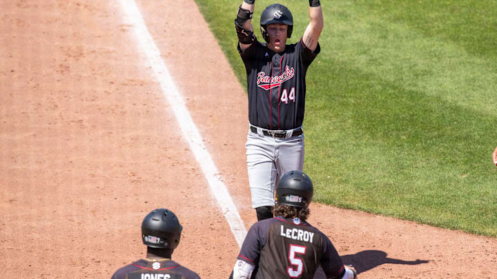 South Carolina baseball players Dalton Reeves, Talmadge LeCroy, and Kennedy Jones celebrate a home run by Reeves