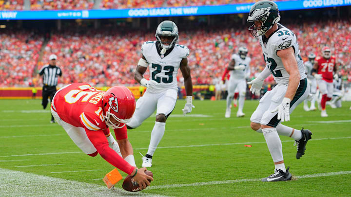 Sep 14, 2025; Kansas City, Missouri, USA; Kansas City Chiefs quarterback Patrick Mahomes (15) scores a touchdown defended by Philadelphia Eagles cornerback Jakorian Bennett (23) and defensive end Za'Darius Smith (52) during the second quarter of the game at GEHA Field at Arrowhead Stadium. Mandatory Credit: Jay Biggerstaff-Imagn Images