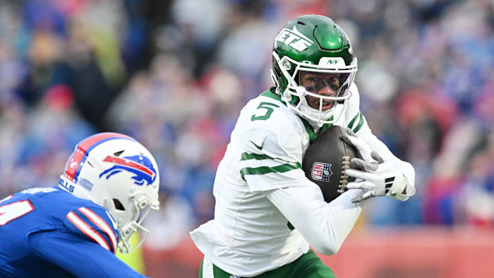 Dec 29, 2024; Orchard Park, New York, USA; New York Jets wide receiver Garrett Wilson (5) tries to get past Buffalo Bills safety Cole Bishop (24) after making a catch in the second quarter at Highmark Stadium. Mandatory Credit: Mark Konezny-Imagn Images