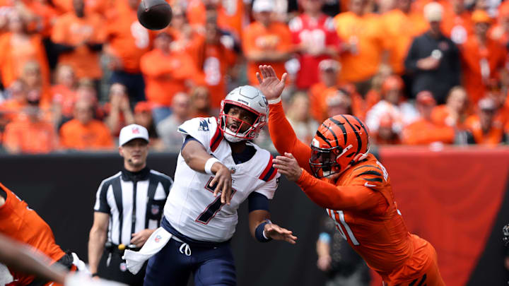 Sep 8, 2024; Cincinnati, Ohio, USA;  New England Patriots quarterback Jacoby Brissett drops to throw as Cincinnati Bengals defensive end Trey Hendrickson (91) applies the pass pressure during the first quarter at Paycor Stadium. Mandatory Credit: Joseph Maiorana-Imagn Images