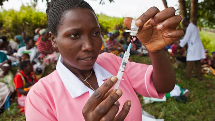 Nurse Agnes from Uganda’s Bwindi Community Hospital prepares a vaccination against measles.